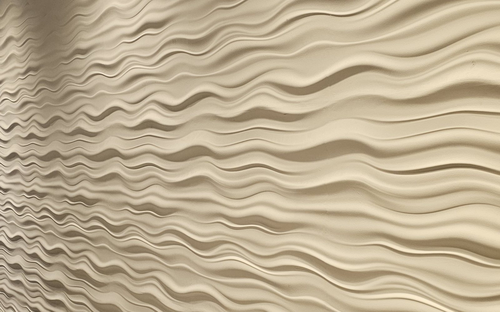 A sculpted relief wall, lit from the side